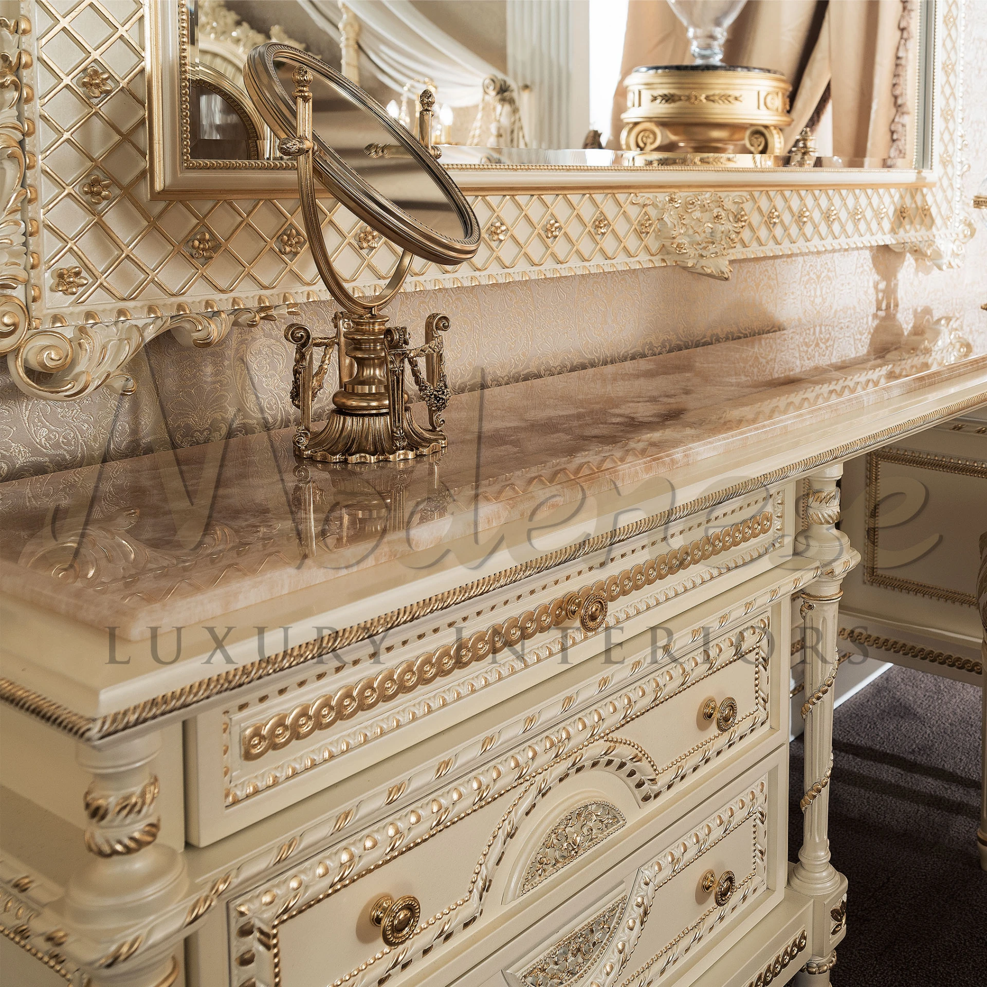 An elaborate, long dressing table with a luxurious onyx stone top and a cream-colored base featuring six drawers with intricate beading and ornate metal handles. 