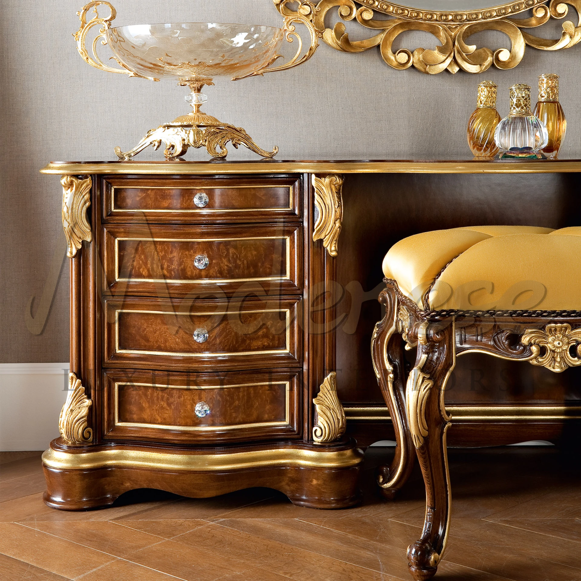 Rich mahogany dressing table with gold leaf accents, crystal drawer knobs, and a cushioned stool in a matching design, complemented by an ornate gold centerpiece bowl.