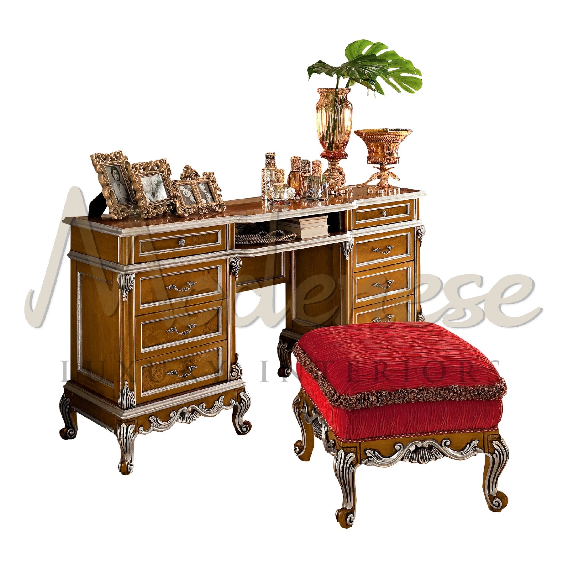 Richly detailed dressing table with brass accents and a regal red stool, showcasing a collection of ornate perfume bottles and framed photographs.