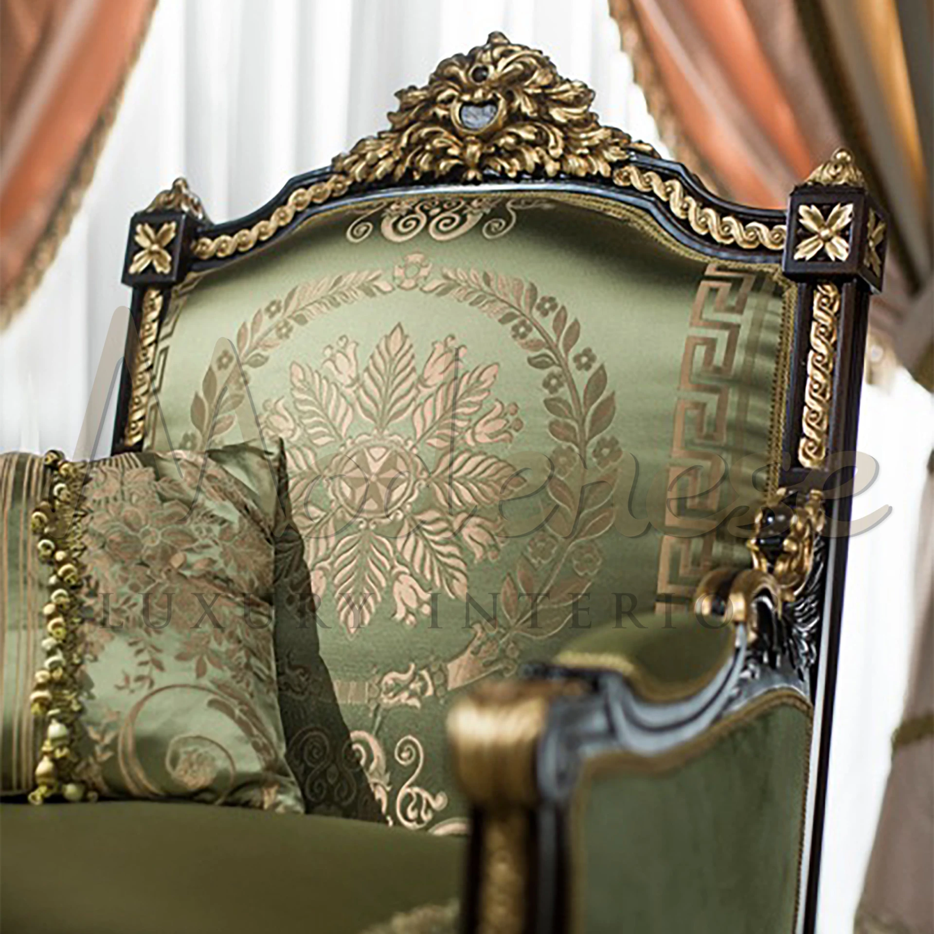 Plush emerald upholstered armchair featuring detailed gold leaf motifs on an antique black wooden frame with luxurious pillows.