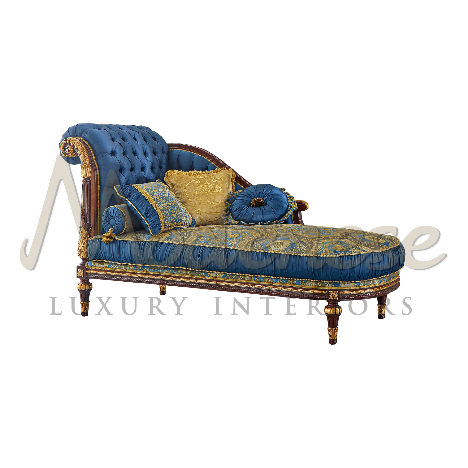 Regal blue tufted chaise lounge with gold patterned upholstery and decorative pillows.                                                                               