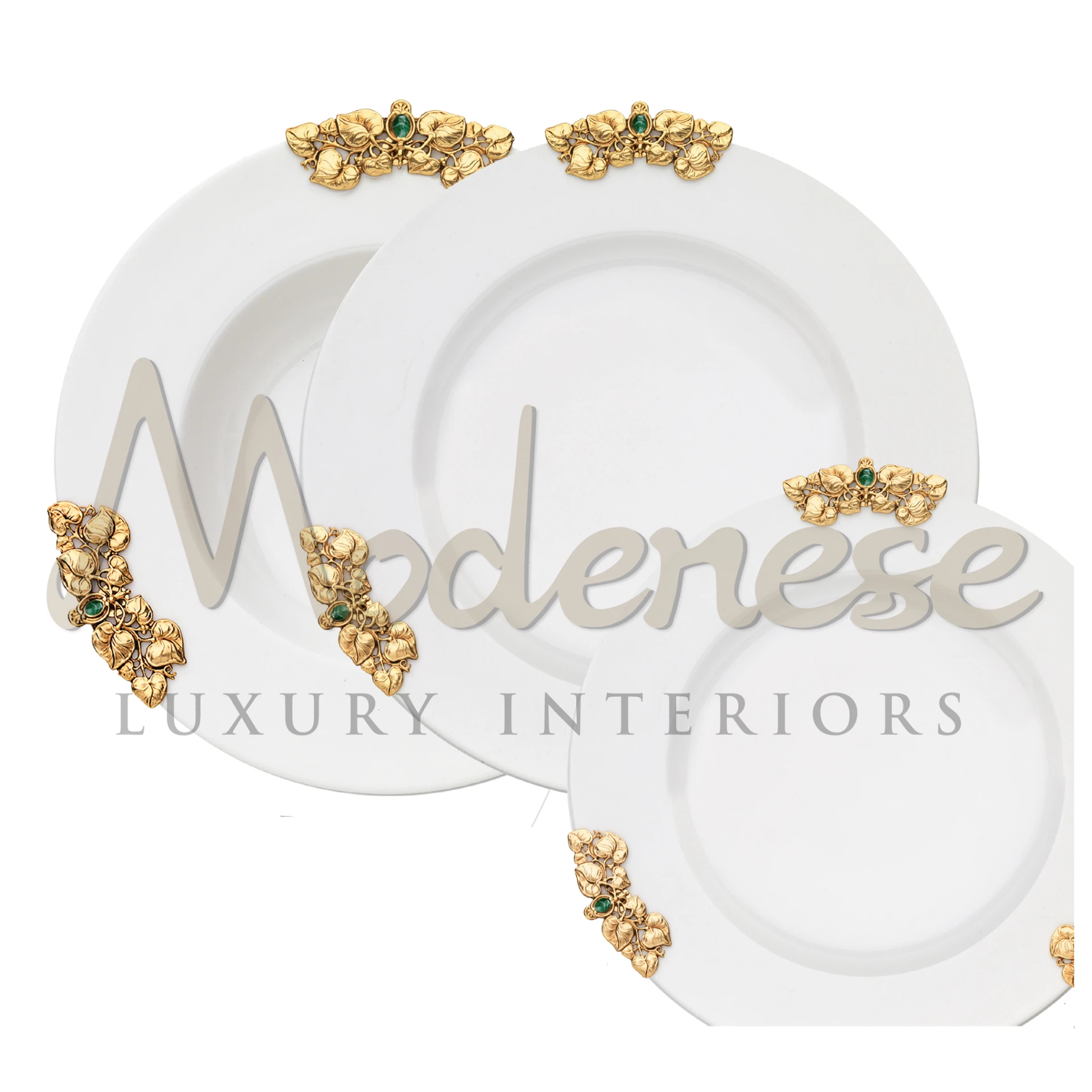 Three white plates, each with intricate golden floral designs and green gemstones.