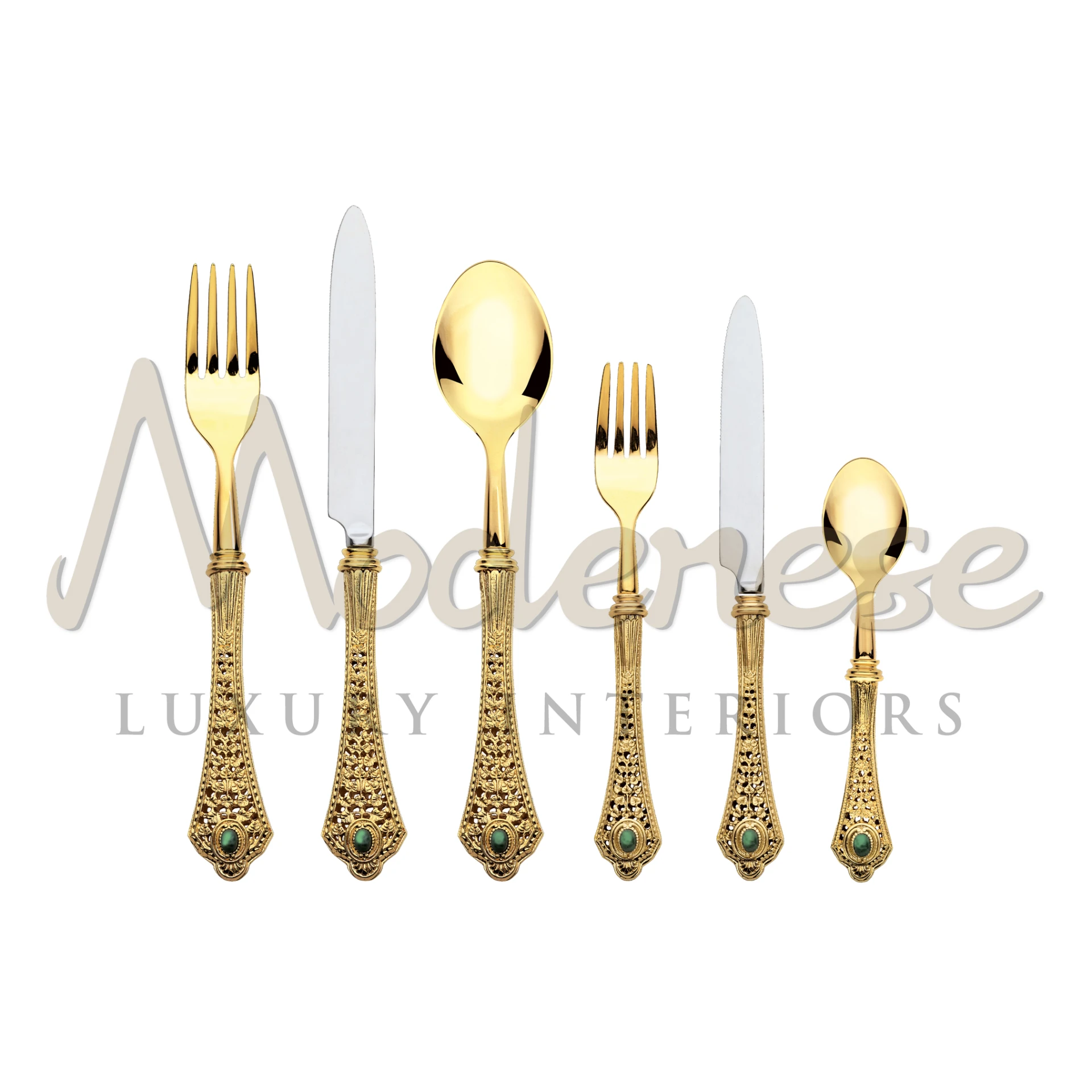 A luxurious Bronze & Inox cutlery set featuring intricate patterns and shiny green gems on the handles, set against a plain backdrop.