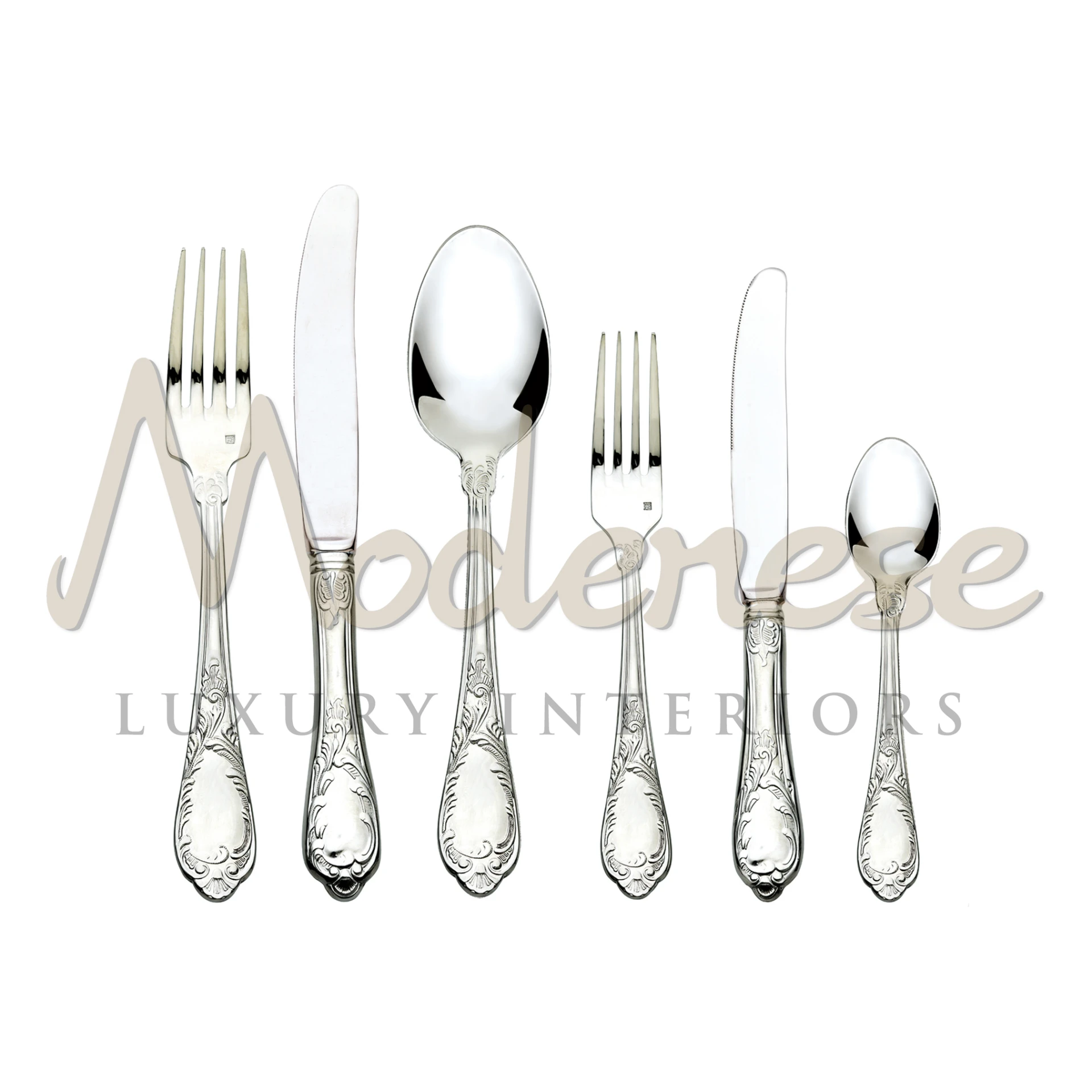 A pristine Inox cutlery set, featuring intricate floral designs on the handles, displayed against a white background.