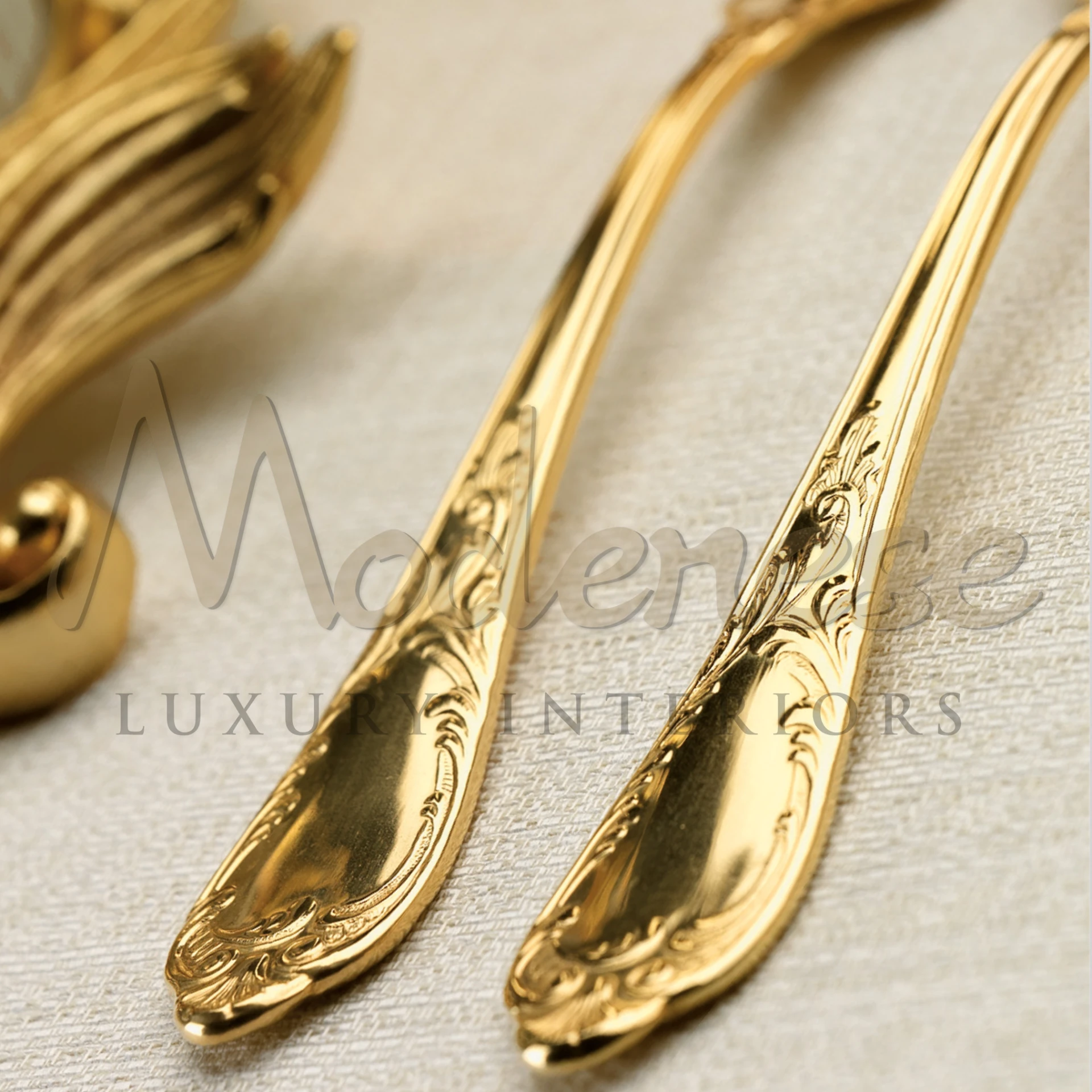 Close-up of decorative gold spoon and fork on table