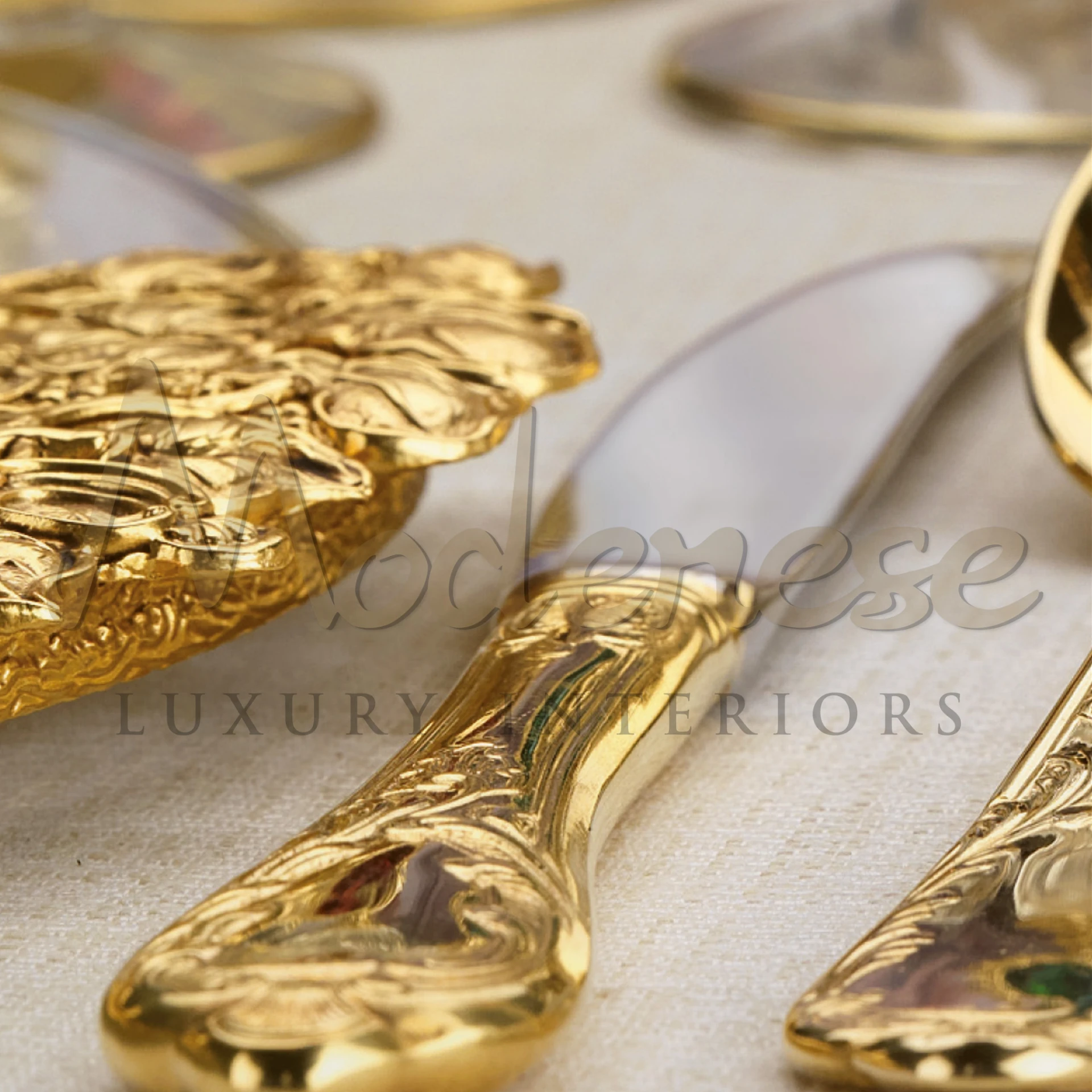 Elegant golden silverware handles with artistic engravings