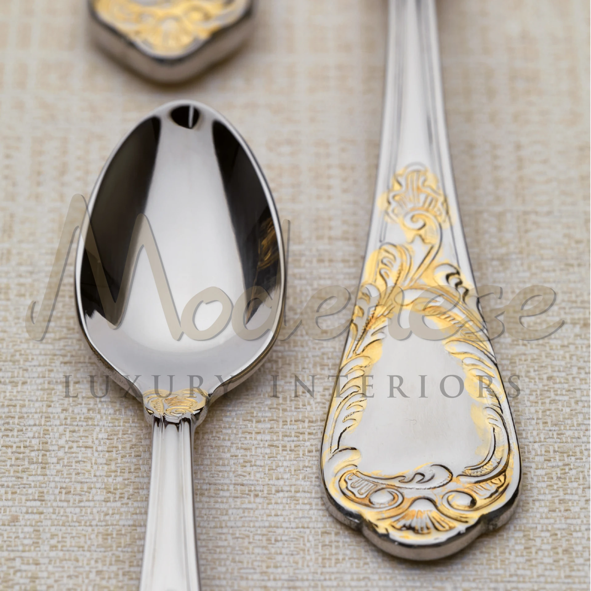 Close-up of an elegant silver spoon with gold detailing on the handle