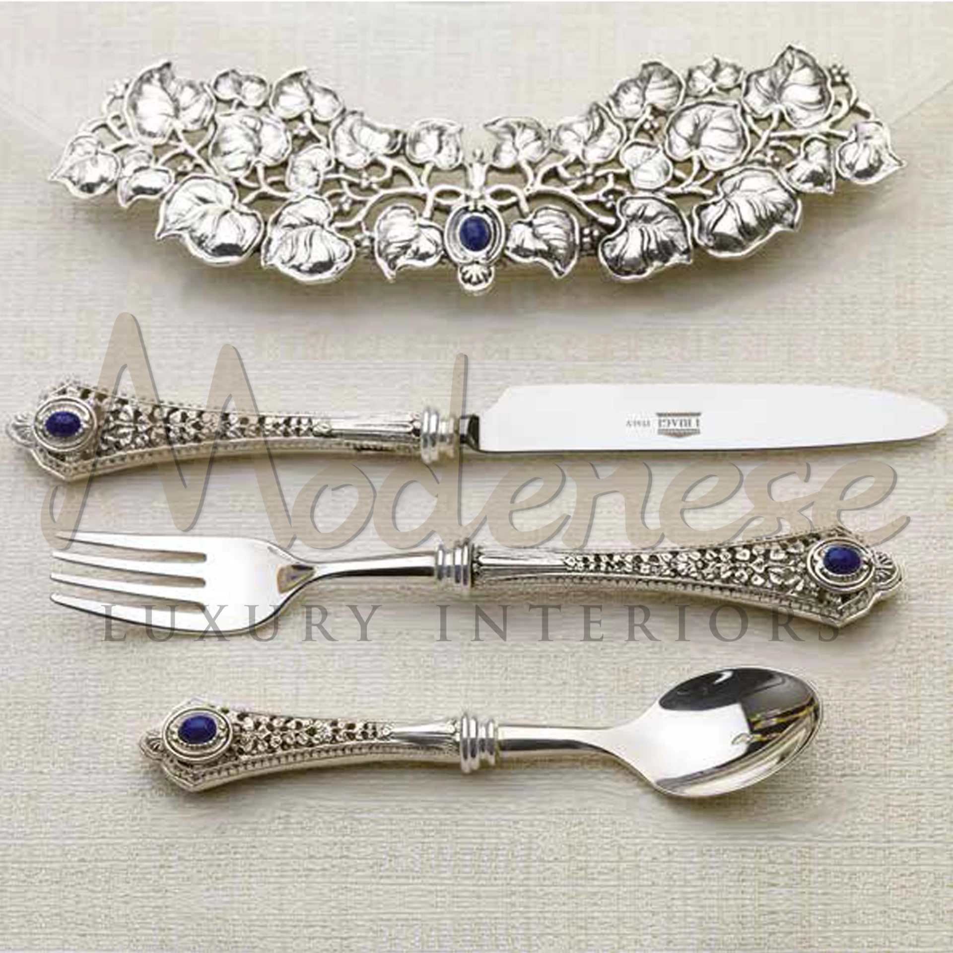 Elegant Modenese Tableware cutlery collection featuring intricate designs and blue stone