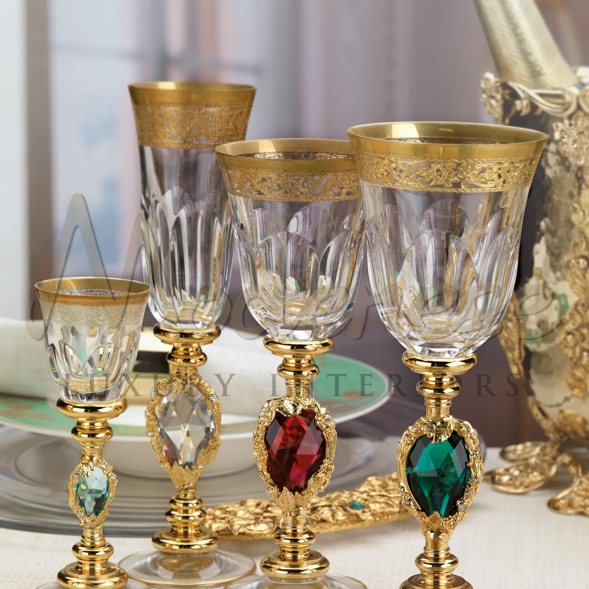Luxurious crystal glassware with gold rims and colorful gemstones in the stems, set against an elegant dining