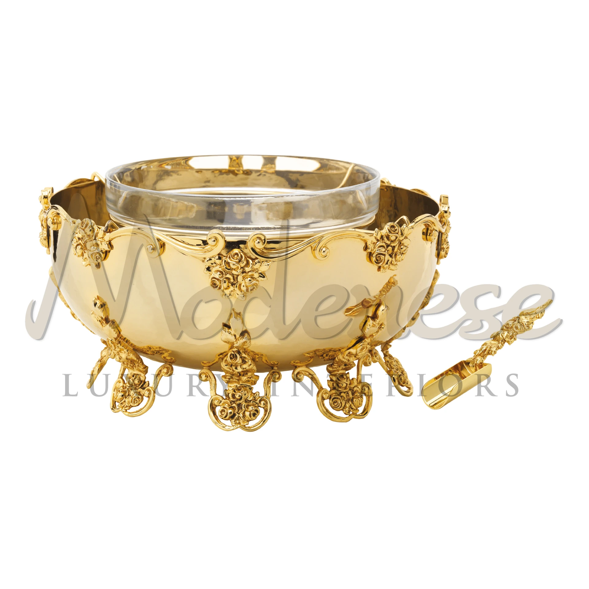 A gold-plated metal caviar server with a crystal glass bowl and a spoon.