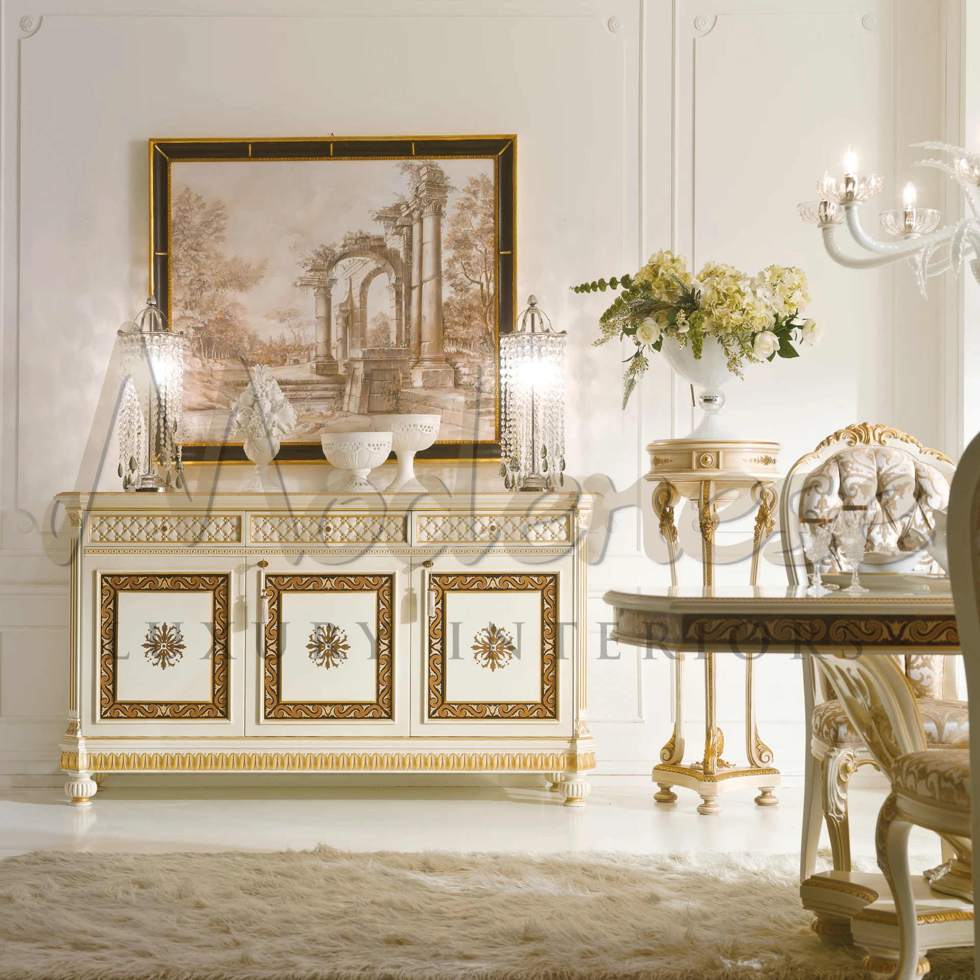 A luxurious room featuring a golden-framed artwork of a classical landscape over 3 doors sideboard.