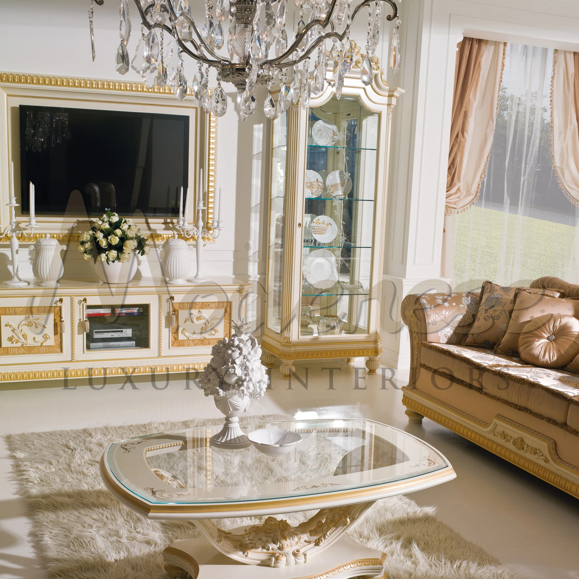 A room with a shiny chandelier, fancy chairs,ivory style cabinet, side table and lots of pretty things.