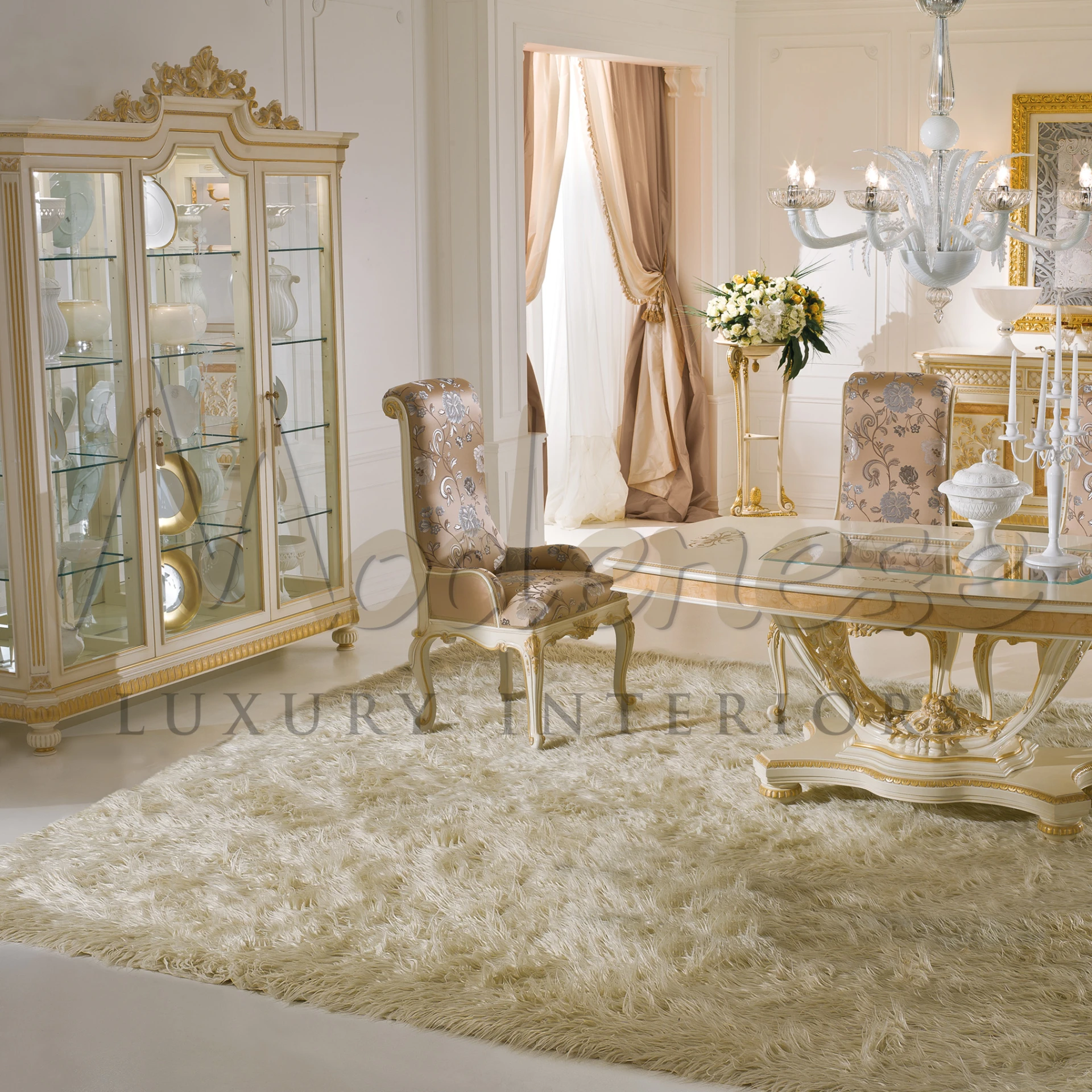 A fancy dining room with a cabinet with glass doors, a fancy table, a chair with patterns.