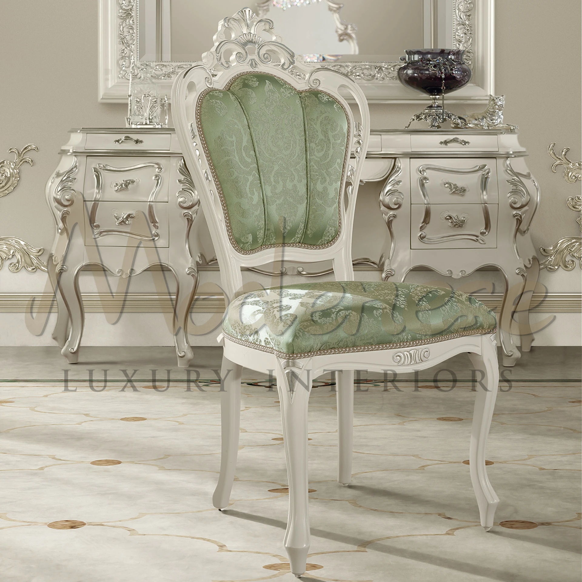 Part of Modenese Furniture's Classic collection, this chair showcases exquisite silver leaf applications, green pattern fabric upholstery, and a curved wooden frame.