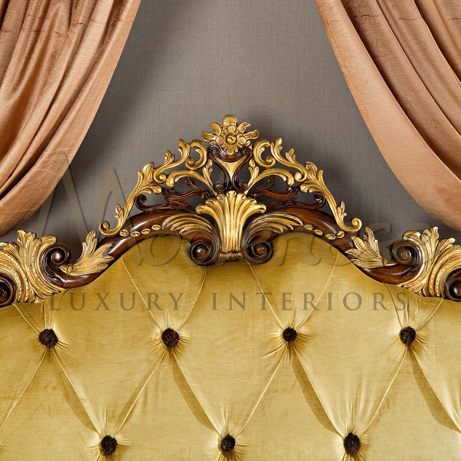 A close-up of a bed's golden tufted headboard from Modenese Furniture with dark wood and intricate gold leaf carvings, flanked by elegant beige curtains.