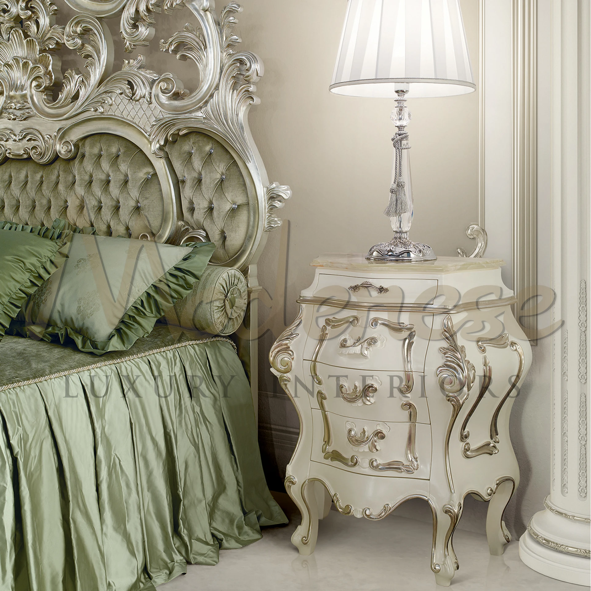 Luxurious Modenese baroque nightstand with detailed carvings and silver trim made, paired with an elegant lamp, beside a tufted headboard. 100% made in Italy.
